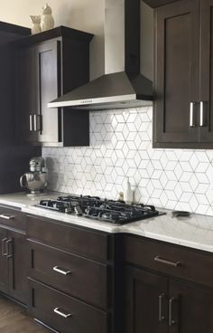 a stove top oven sitting inside of a kitchen next to wooden cabinets and cupboards