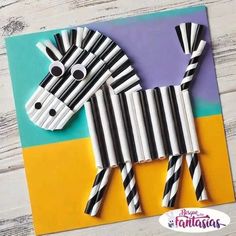 a zebra made out of paper and some black and white stripes on the bottom of it