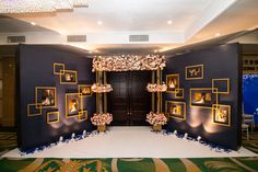 an entrance decorated with flowers and candles for a wedding or reception event in a hotel lobby