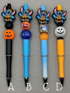 four different colored pens with cartoon characters on them