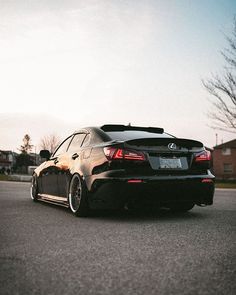 a black car is parked on the street