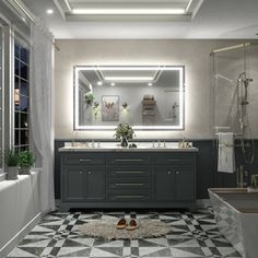 a bathroom with two sinks and a large mirror above the sink is lit by recessed lights