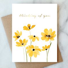 a card with yellow flowers and the words thinking of you