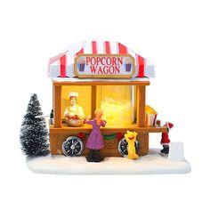 a small toy food cart with people standing outside