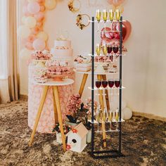 a party with balloons, cake and champagnes on the table in front of it