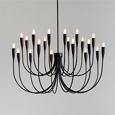 a large chandelier with many lights hanging from it's sides and black cords