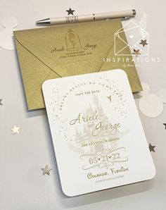 an envelope with a gold foil stamp on it and some confetti around it