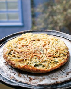 a pizza sitting on top of a pan covered in cheese