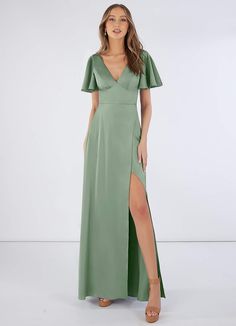 a woman in a long green dress with a slit down the side and short sleeves