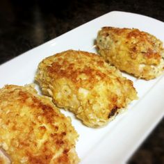 three fried chicken patties on a white plate