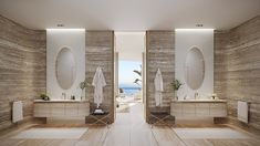 a large bathroom with two sinks and mirrors