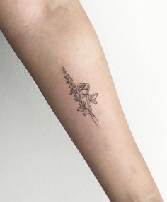 a woman's arm with a flower tattoo on the left side of her arm