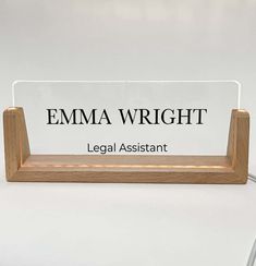 a glass plaque with the words legal assistant on it and an image of a wooden stand