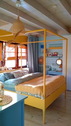 a bed sitting in the middle of a bedroom next to a window