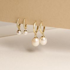 These aren’t your grandmother’s pearls. We’re finding new ways to reimagine this classic gem for the modern woman. At our NYC headquarters, we’re designing new jewelry styles that touch on the latest trends, while still being completely timeless and fairly-priced. Since quality is always top of mind, we use only freshwater-cultured pearls, set in gold that won’t tarnish or flake. While they may not be an heirloom yet, they’ll be something that you can pass down to the next generations. 14k Yello Pearl Huggies, Danty Jewelry, Engagement Jewellery, Jewelry Drawer, Jewelry Photoshoot, Jewelry Styles, Pearl And Diamond Earrings, Gold Pearl Earrings, Expensive Jewelry