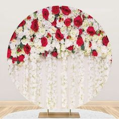 an arrangement of red and white flowers on a table