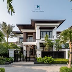 a large white and brown house with palm trees