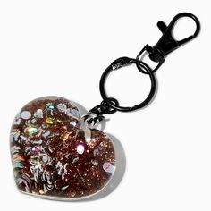 a heart shaped keychain with lots of glitter on it