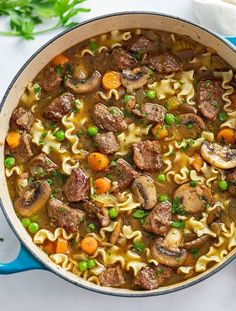 a pot filled with pasta, meat and vegetables