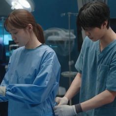 two people in scrubs are standing near each other