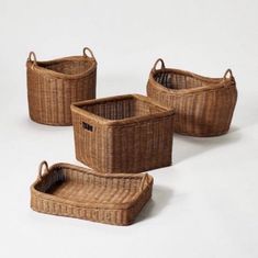 four woven baskets with handles on white background