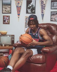 a man sitting in a chair holding a basketball