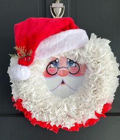 a christmas wreath with santa claus's face on it