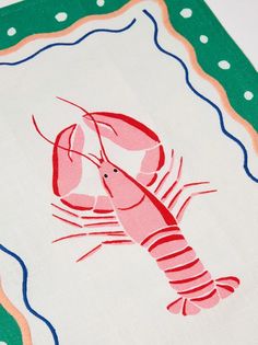 a red lobster on a green and white placemat