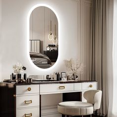 a dressing table with a mirror, stool and chair in front of the window that is lit up