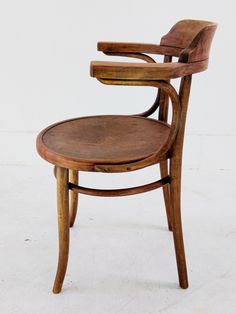 a wooden chair sitting on top of a white floor