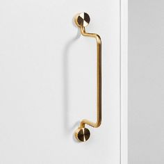 an open door with a handle and two balls on the handle, in gold tone