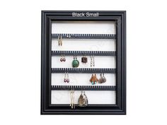 a black framed display case with earrings and earring hooks on the bottom shelf that says,'black - small '