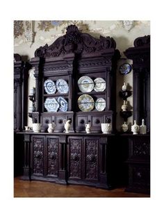 an antique china cabinet with plates on it