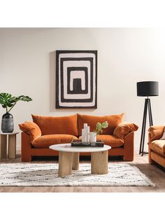 a living room with two couches, a coffee table and a plant in the corner