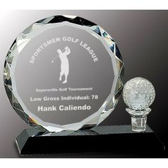 a glass trophy with a golf ball on it