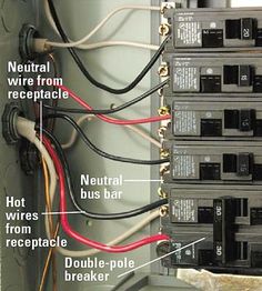 an electrical panel with multiple wires attached to it and labeled in red, white, and black