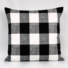 a black and white checkered pillow sitting on top of a table