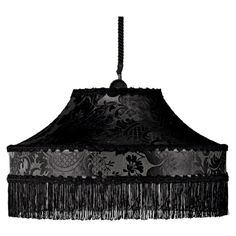 a black lamp shade with fringes hanging from it