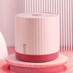 a white and pink object sitting on top of a round plate next to a wall