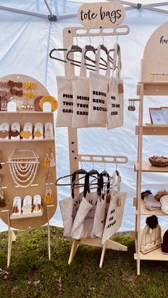 an assortment of items on display in front of a tent with the words tote bags