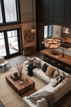 a living room filled with furniture next to a kitchen and an open floor plan area