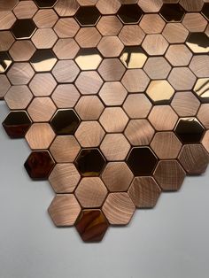 a close up view of a wall made out of hexagonal tiles with gold foil