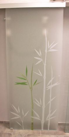 an image of a bamboo plant painted on the side of a glass wall in a bathroom