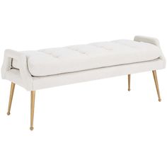 a white bench with gold legs and a tufted upholstered seat on it