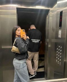 a woman taking a selfie in an elevator