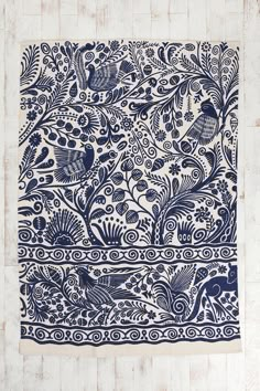 an intricately designed blue and white cloth hanging on a wall