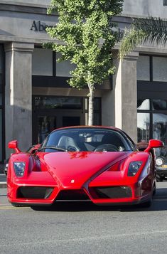 a red sports car parked in front of a building