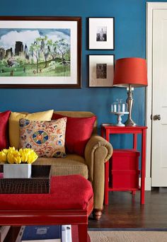 a living room with blue walls and red furniture