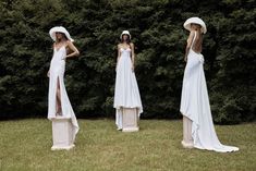 three models wearing white dresses and hats