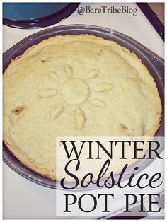 a pie sitting on top of a pan with the words winter solstice pot pie